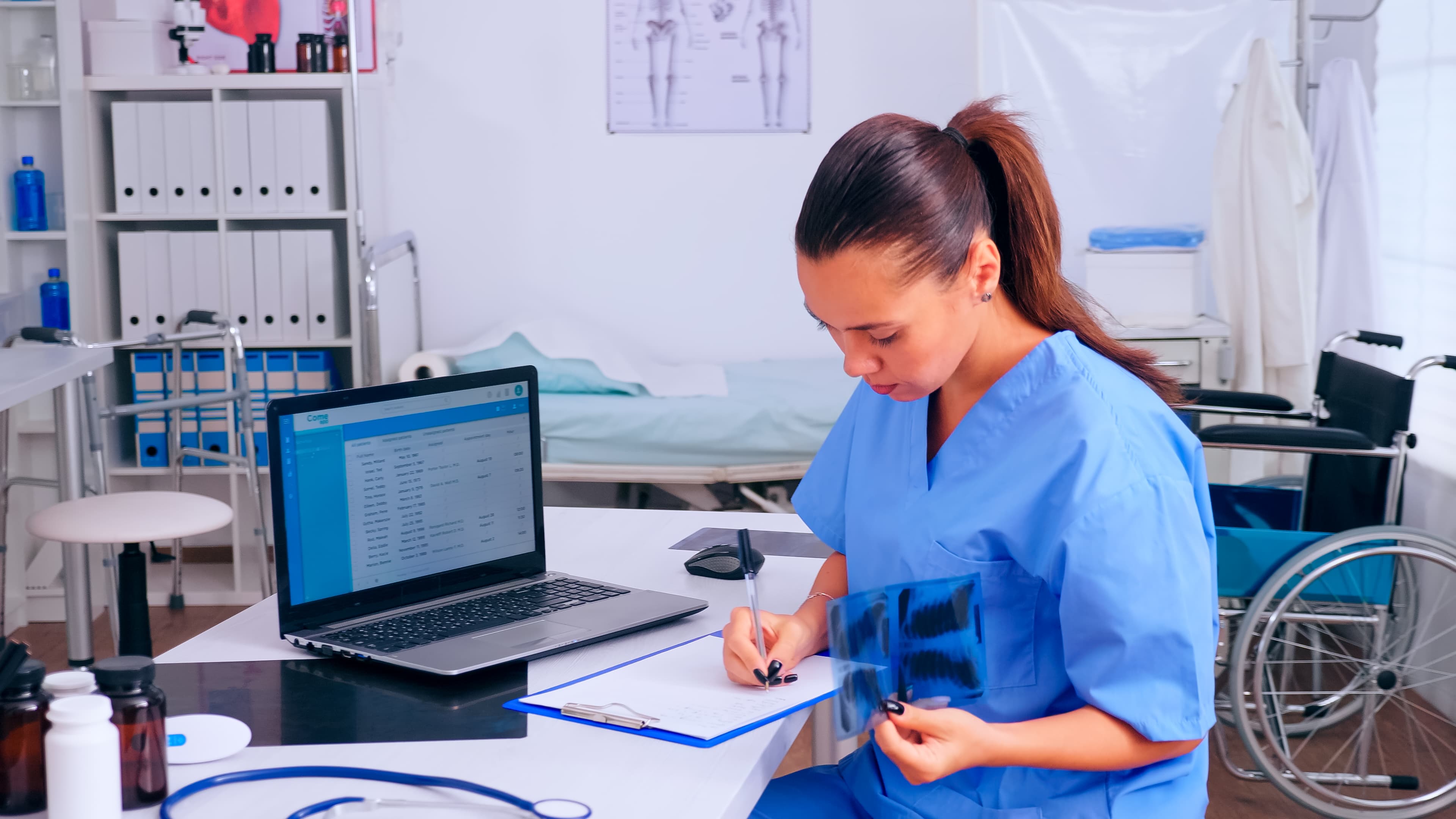 Nurse reviewing x-ray results and patient notes for evidence-based practice
